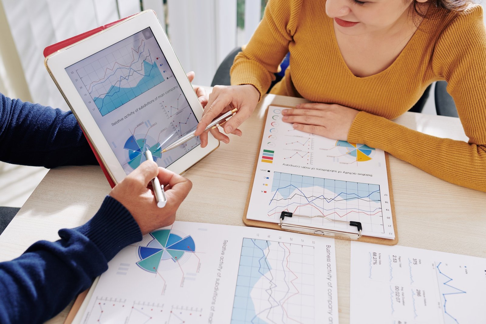 Business leaders reviewing financial information for an acquisition